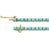   14K yellow gold line design adorned with natural turquoise stones measuring 2.5 mm each. 