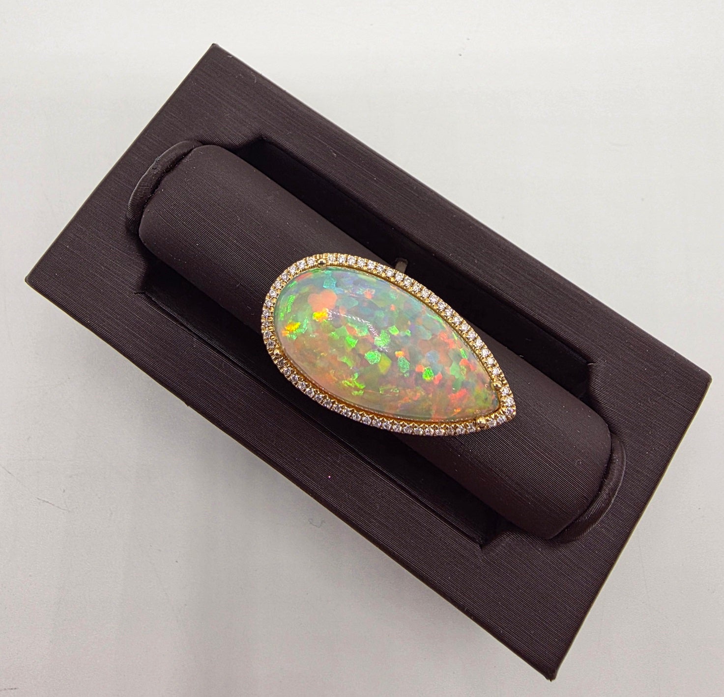 Scintillating Pear Shape Opal and Pave Diamond Halo Ring in 14K Yellow Gold