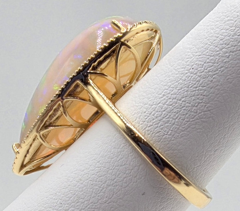 Scintillating Pear Shape Opal and Pave Diamond Halo Ring in 14K Yellow Gold