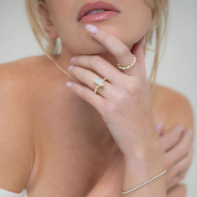  The two-tone polished rhodium finish 14 karat yellow and white gold setting adds 