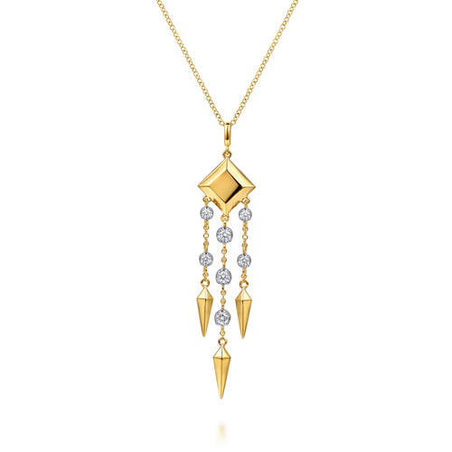 A gold pendant necklace featuring a faceted diamond-shaped centerpiece with three dangling chains. Each chain is adorned with small clear round stones and cone-shaped gold pendants, set against a clean white background.